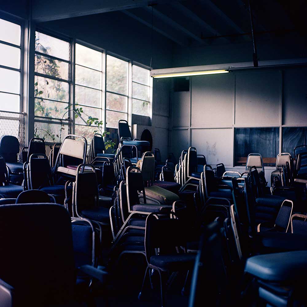 Chairs stacked in one of the abandon buildings inside the McNeil Island Corrections Center.